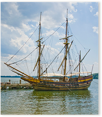 the Maryland Dove ship anchored at a dock on a sunny day